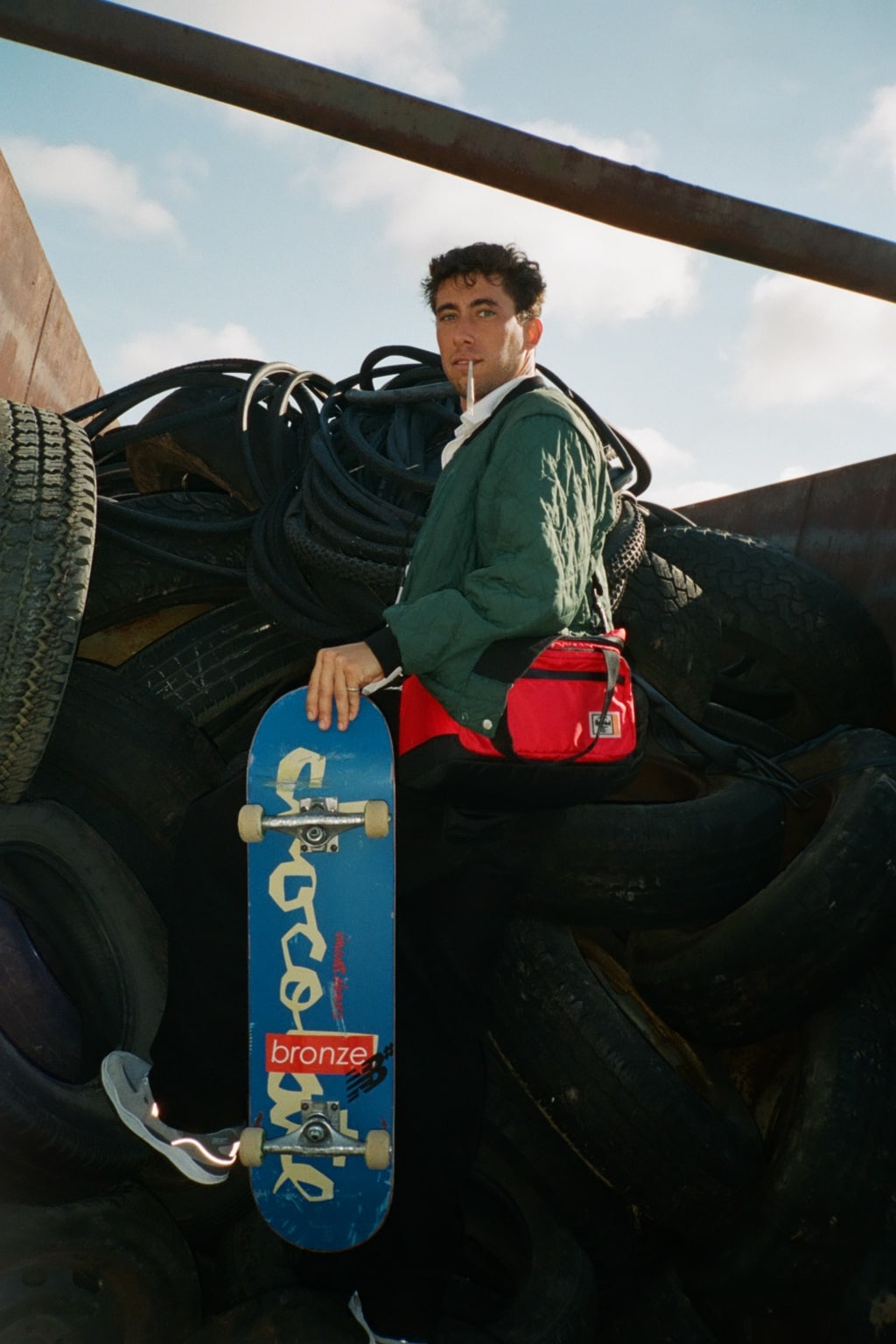 Holding a skateboard with some tires