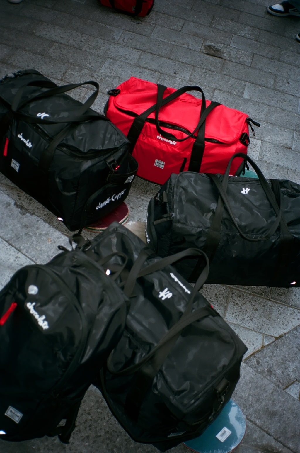 A bunch of bags on top of skateboards