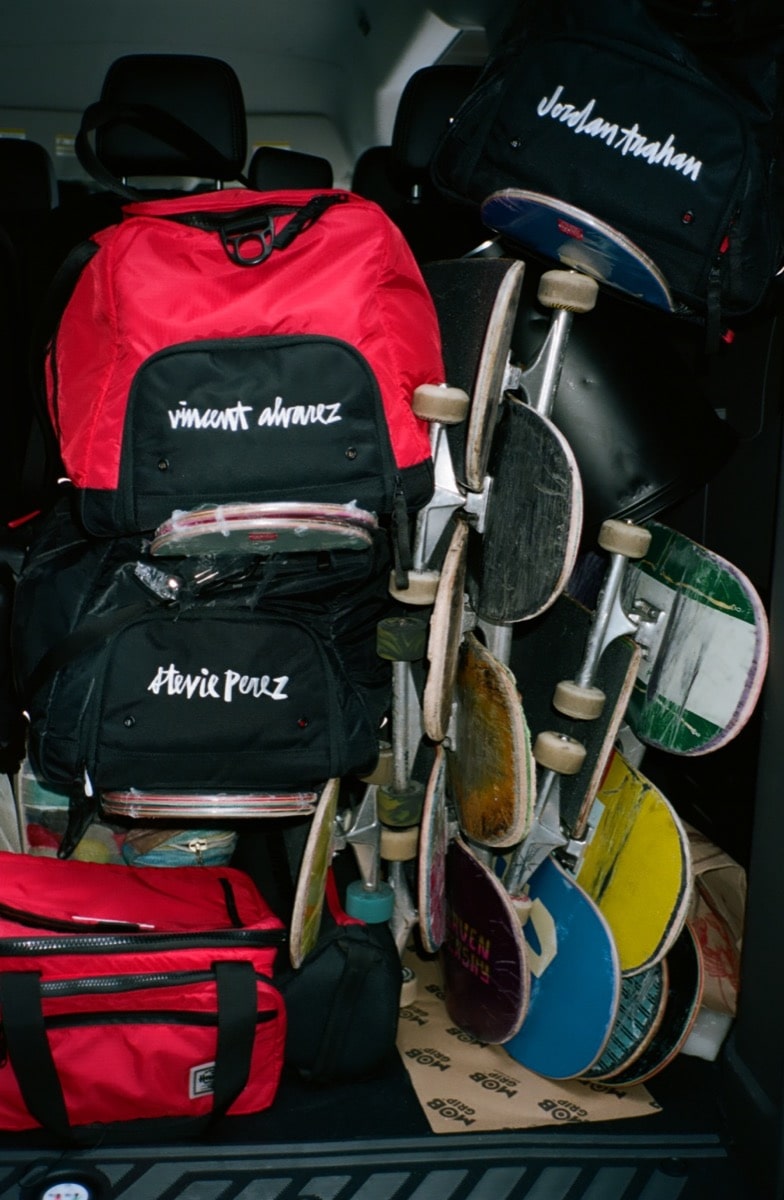 A bunch of skateboards and bags in the back of the van