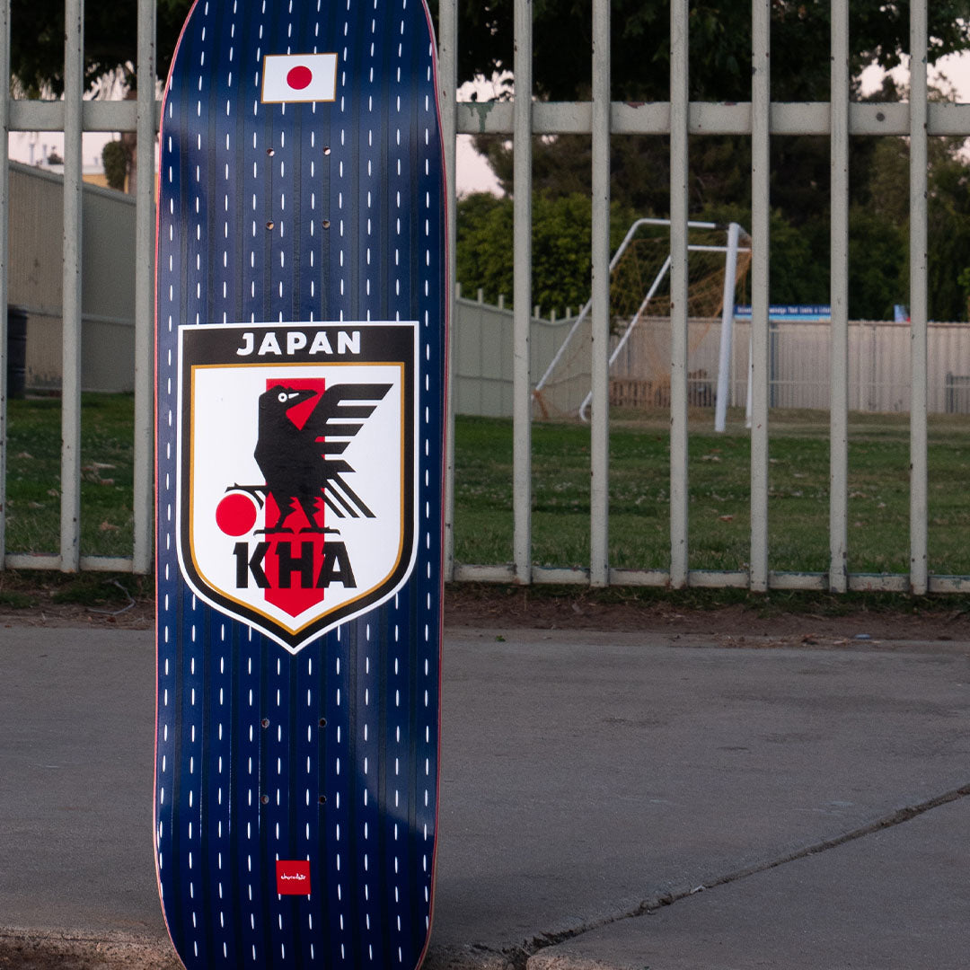 Japan Sakkaa Skateboard near a fence