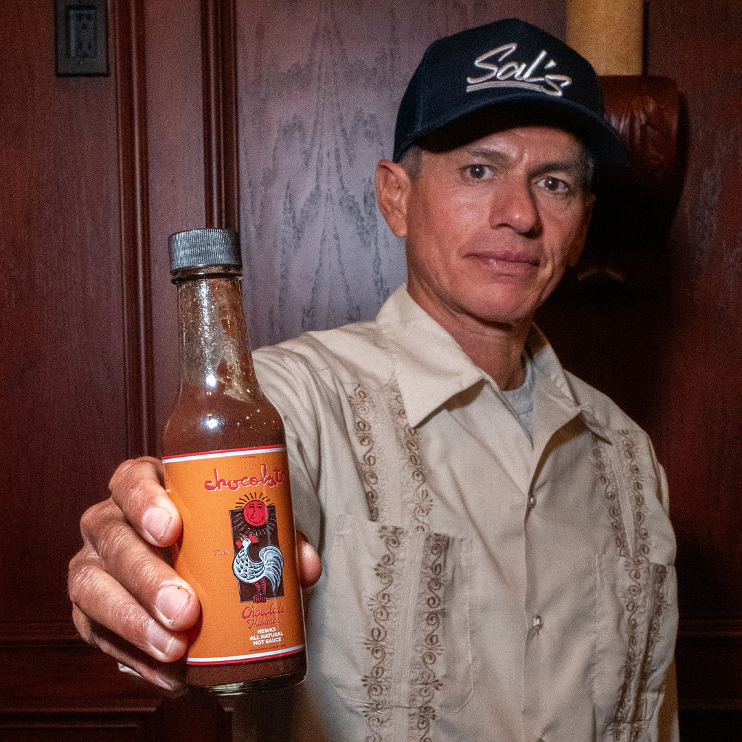 Chico holding hot sauce