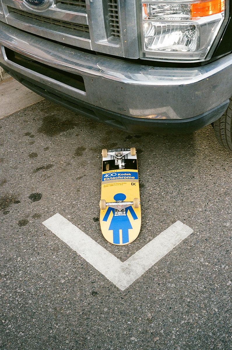 A Kodak skateboard sitting on the road