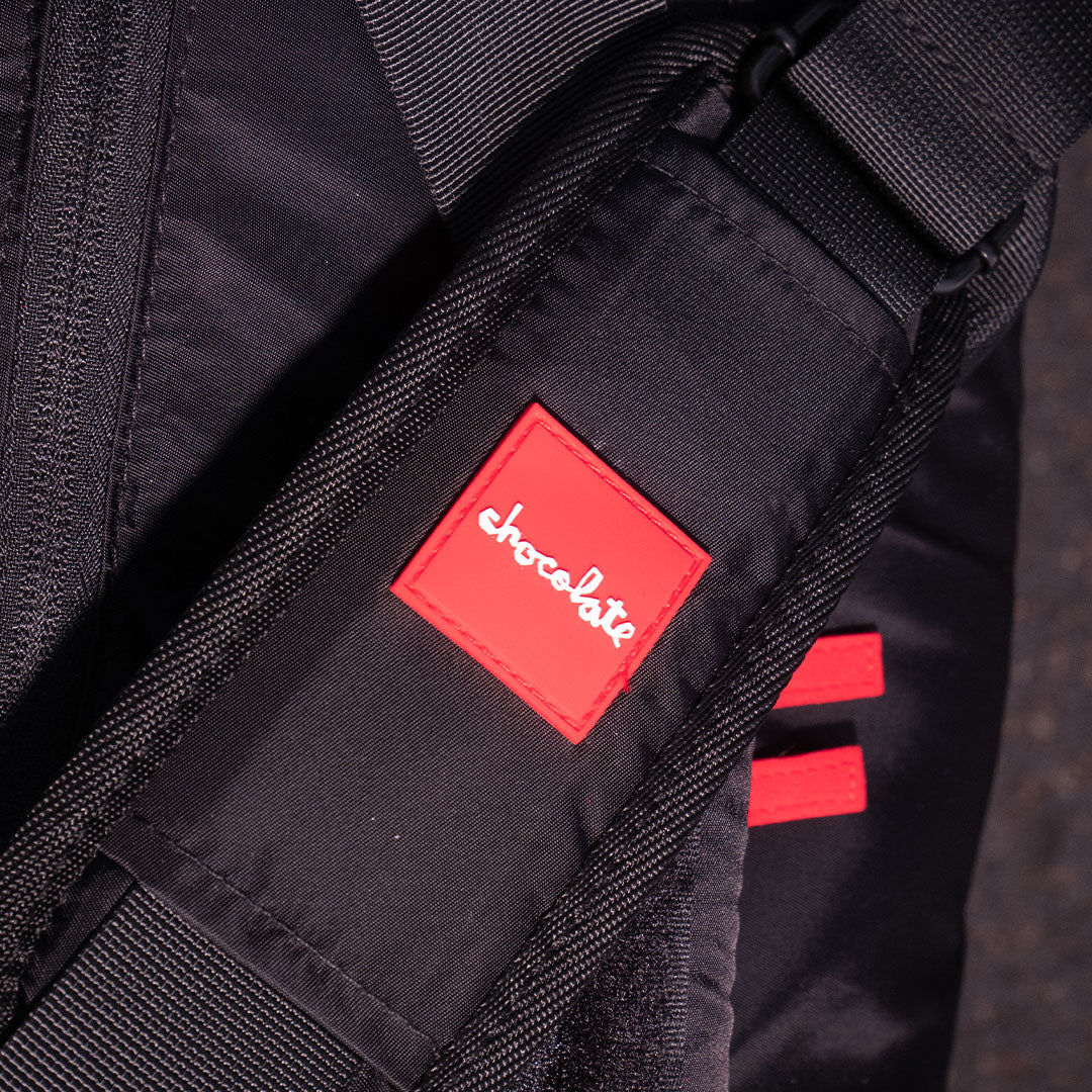 Close-up of a black bag with a red 'Chocolate' logo.