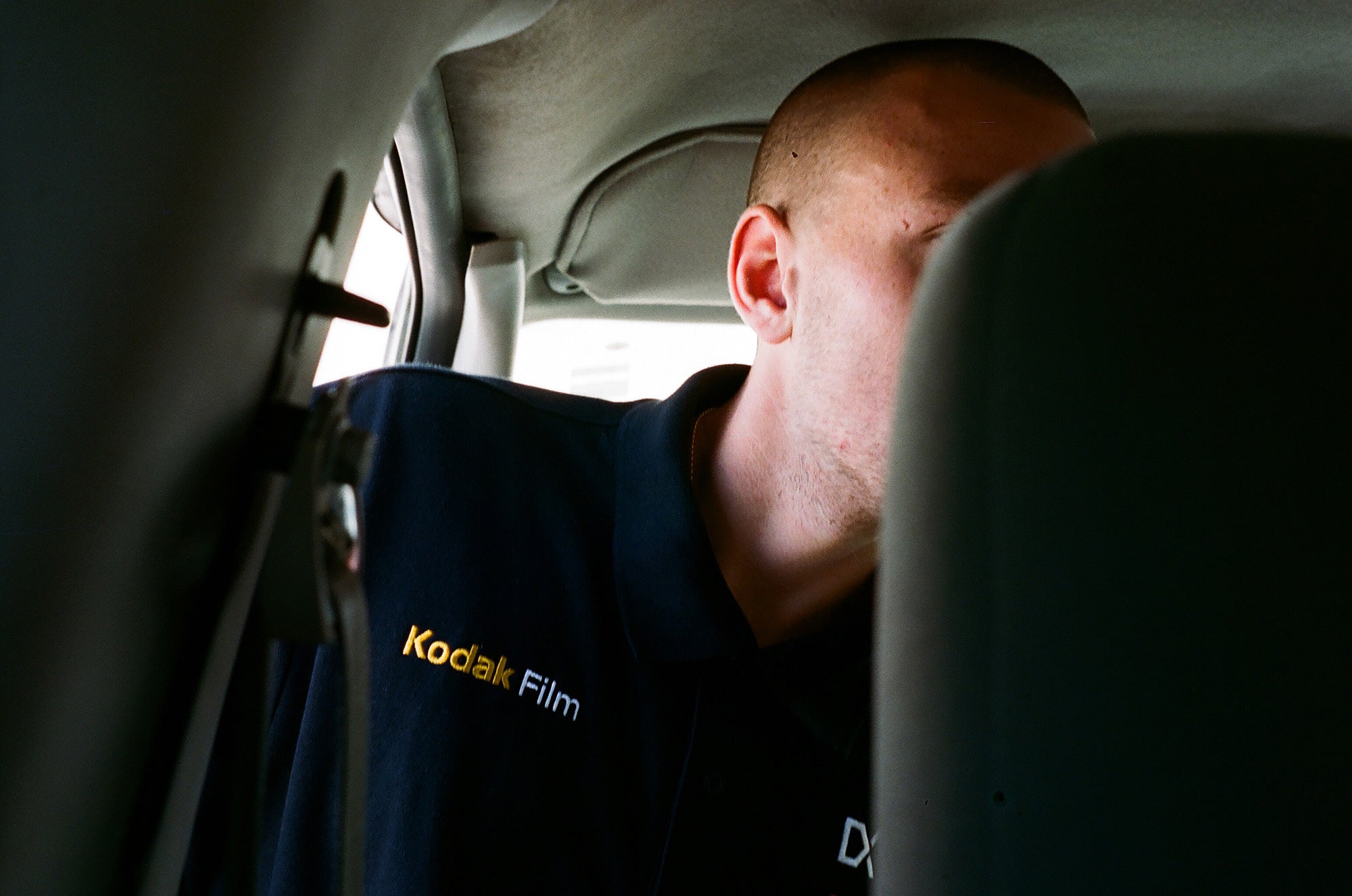 Gass in the van with a Kodak shirt on